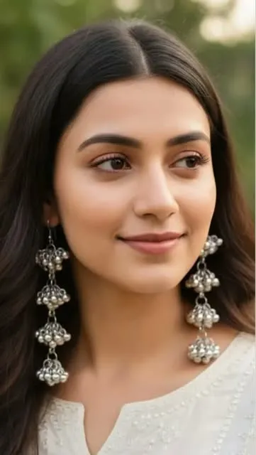 Model wearing three-tier oxidised ghungroo jhumkas